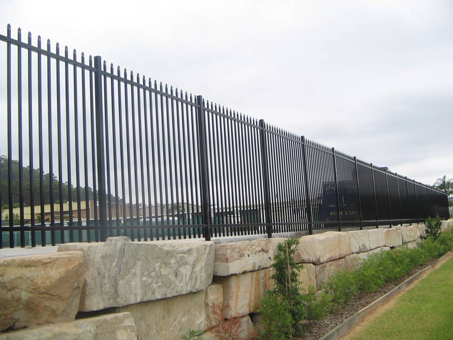 Black steel palisade security fencing on a retaining wall
