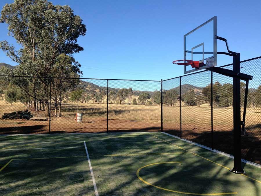Chain wire fencing around an outdoor basketball court
