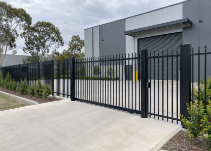 Black aluminium security fence and sliding gate at a commercial building