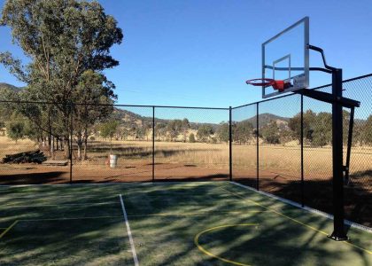 Chain wire fencing around an outdoor basketball court